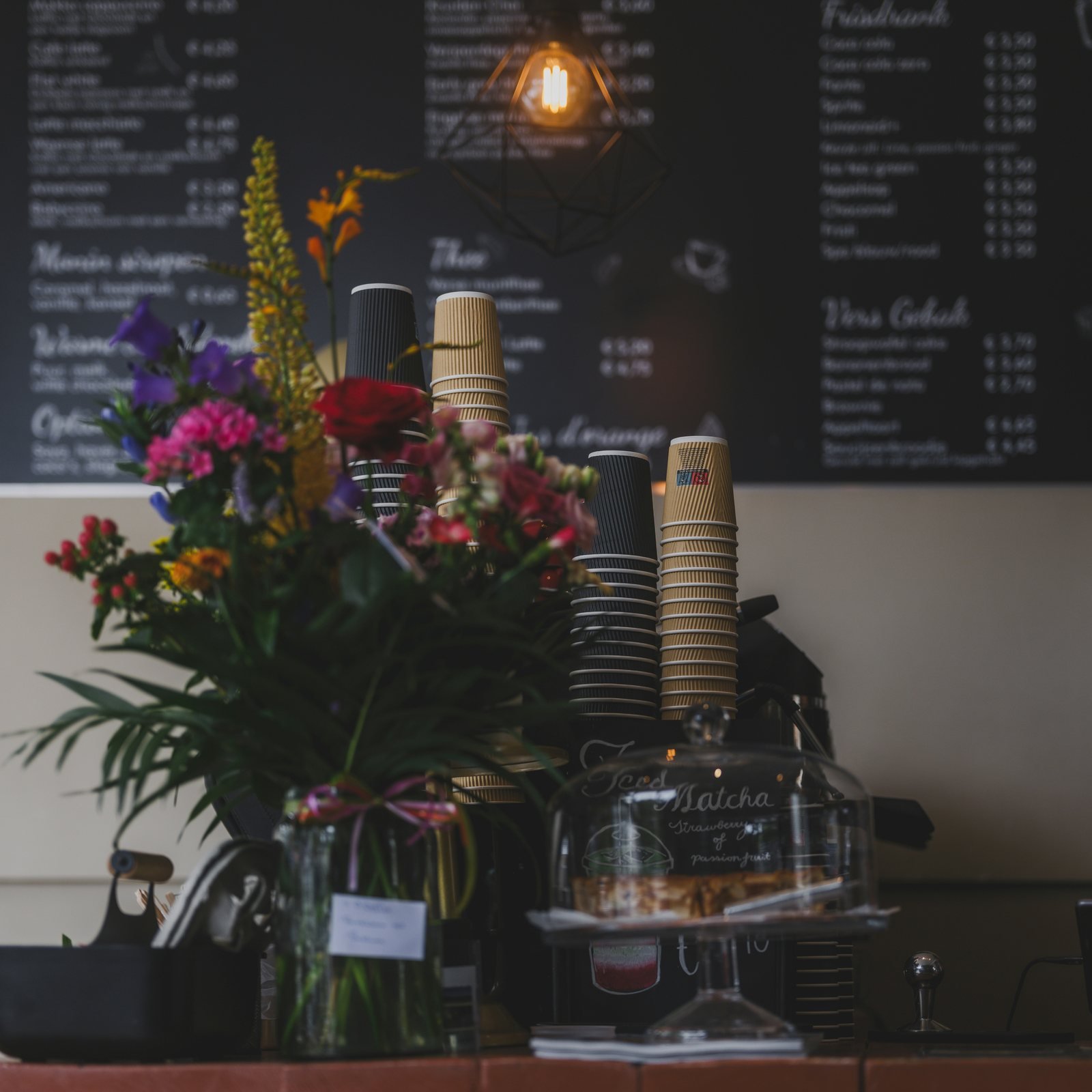 Flowers and a café counter used within a café website direction